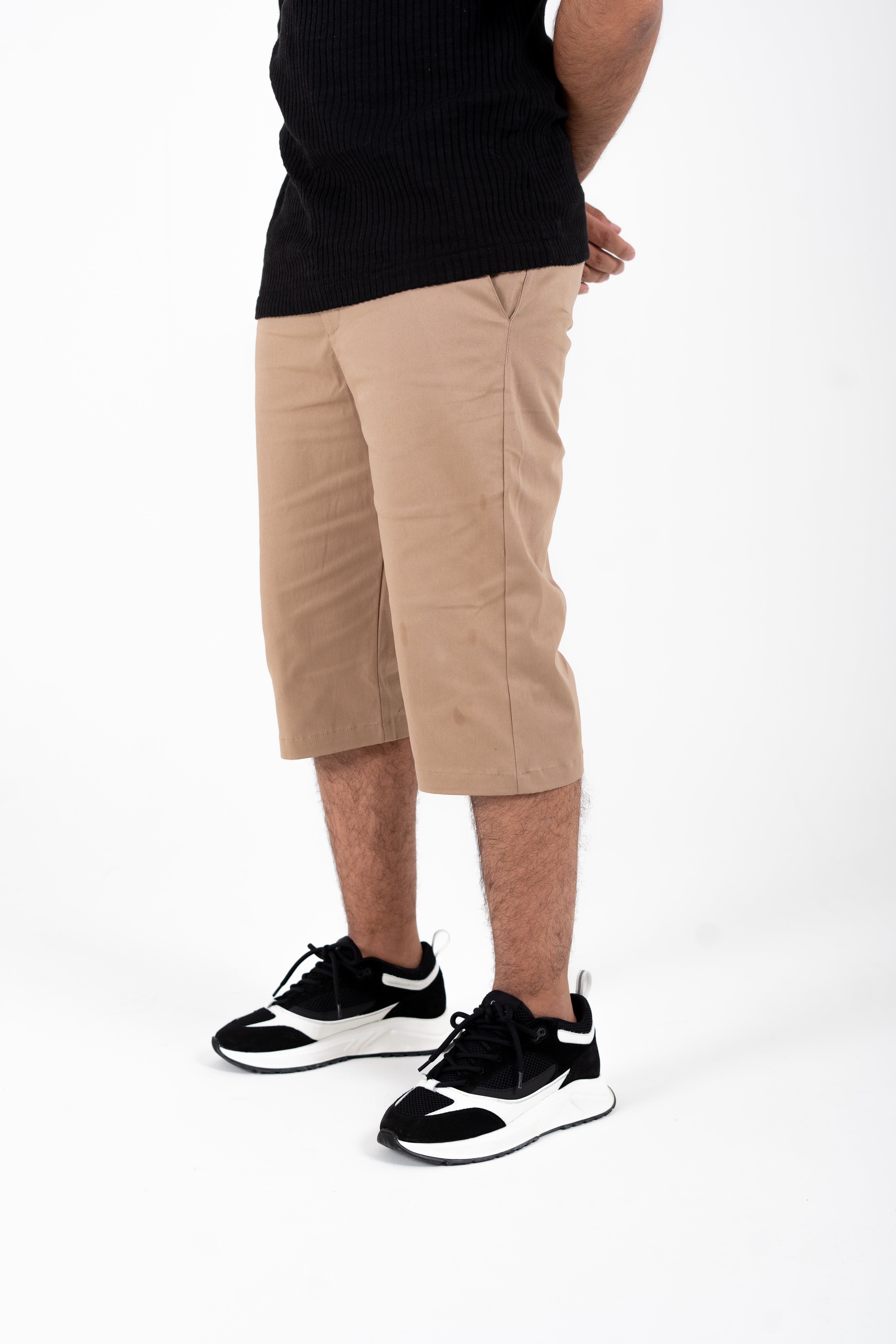 Angled view highlighting knee coverage and modern cut of sand chino shorts

