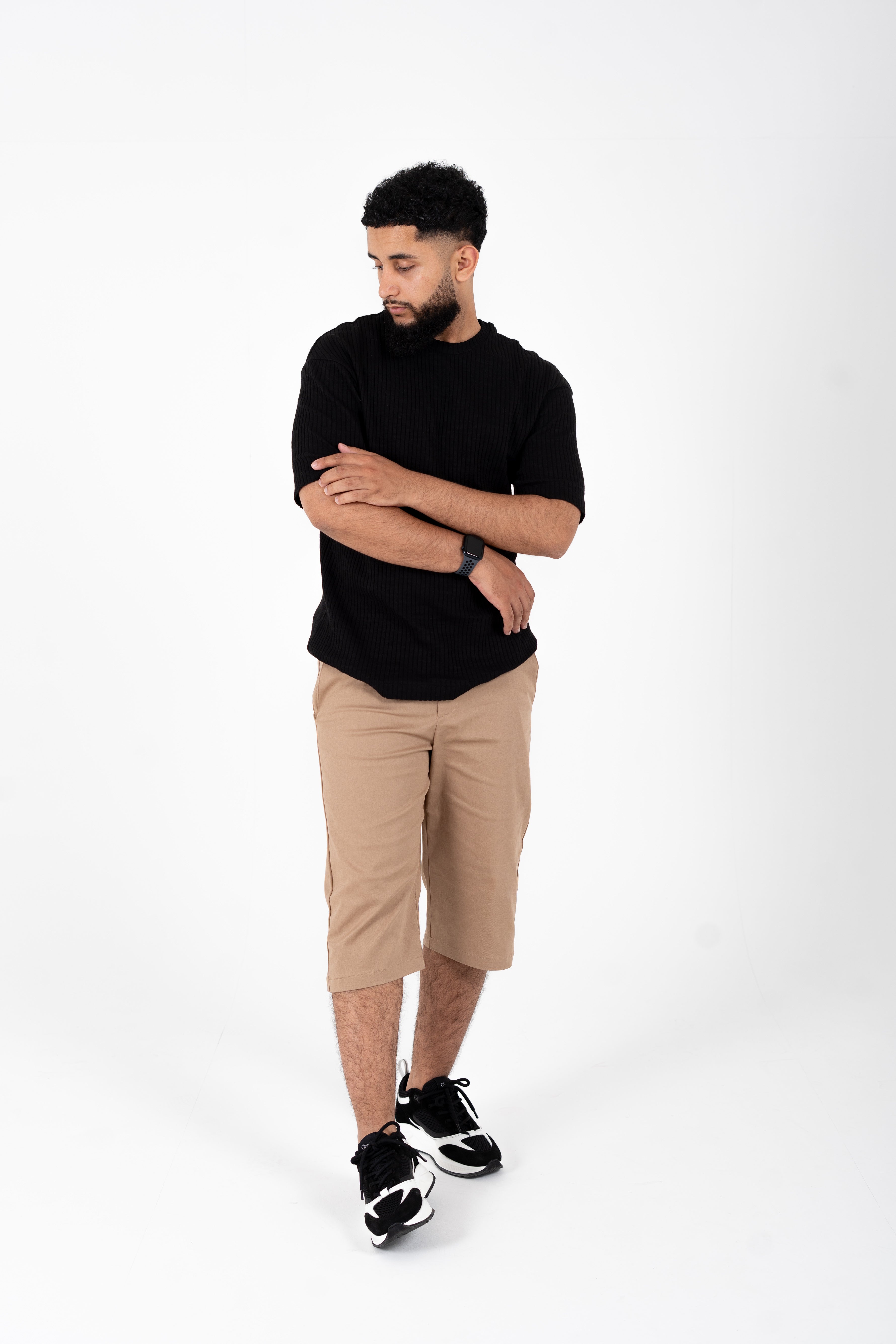 Standing pose in 34ERS® slim chino shorts for men, ideal for summer prayers

