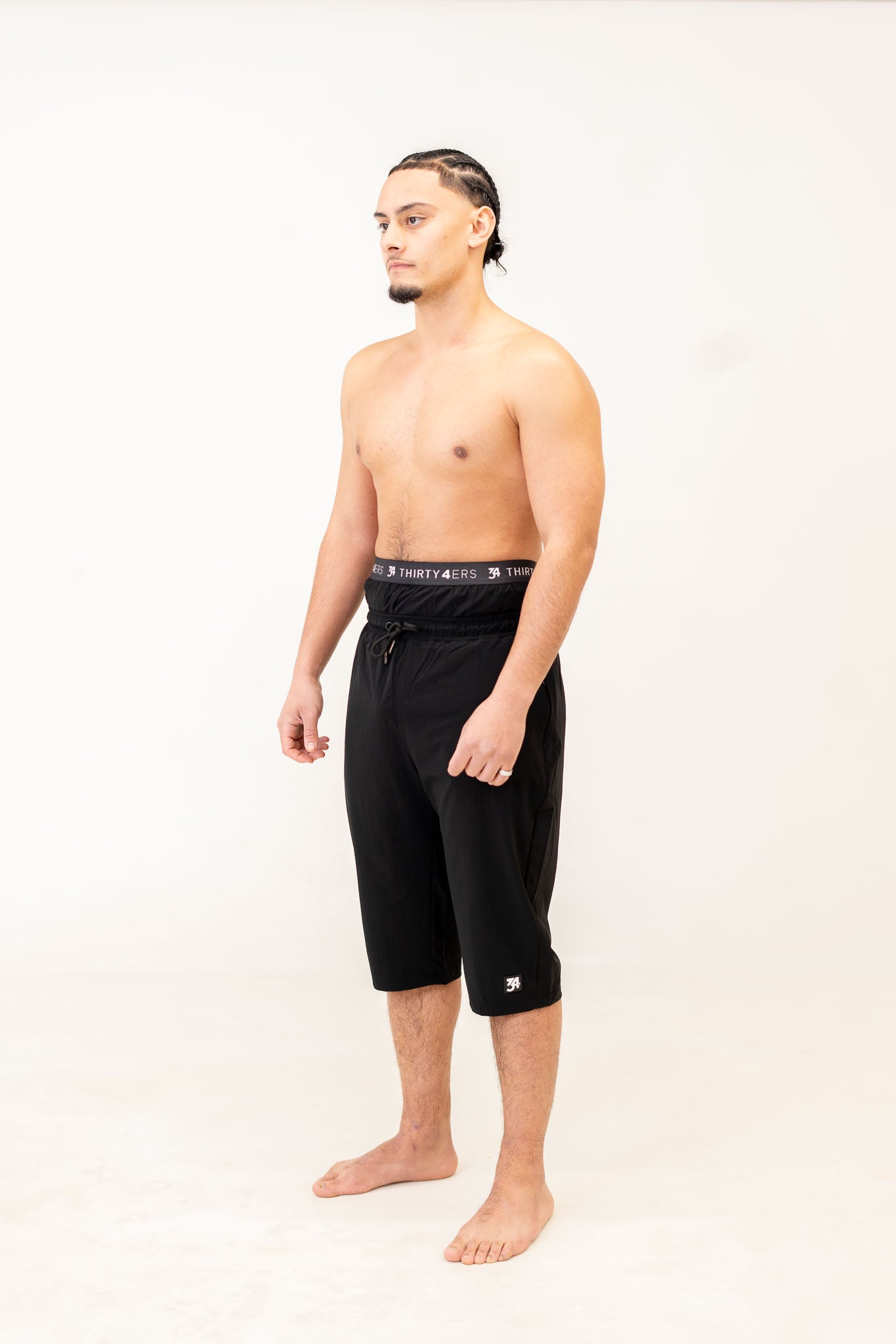 Front view of AWRA Swim Shorts – Black Edition with 3D logo and knee-length fit

